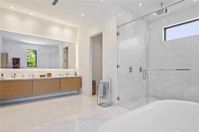 full bathroom featuring double vanity, a marble finish shower, a tub to relax in, and a healthy amount of sunlight