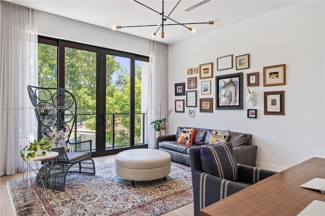 living area with wood finished floors and a chandelier