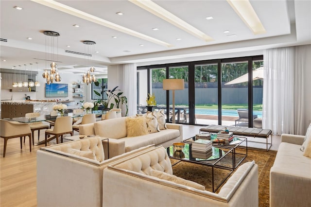 living room featuring light wood finished floors and a chandelier