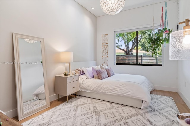 bedroom with baseboards and wood finished floors