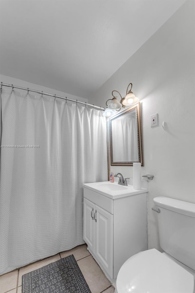 bathroom with vanity, tile patterned flooring, toilet, and curtained shower