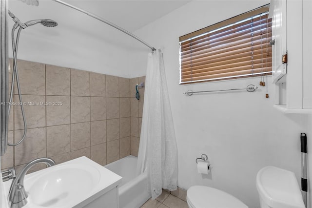 bathroom featuring a sink, tile patterned floors, shower / bath combo, and toilet