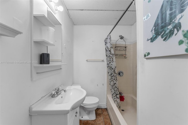 full bath featuring vanity, tile patterned flooring, toilet, shower / bathtub combination with curtain, and a drop ceiling