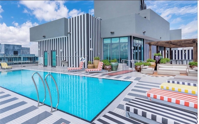 community pool with a patio and a pergola