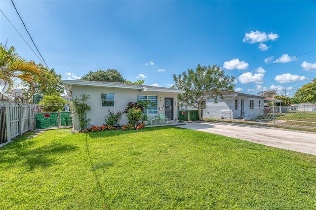 ranch-style house with fence, stucco siding, and a front lawn