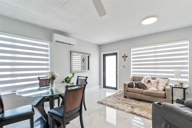 dining space with a textured ceiling, ceiling fan, and a wall mounted air conditioner