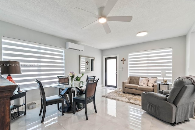 dining space with a textured ceiling, a wall mounted AC, and ceiling fan