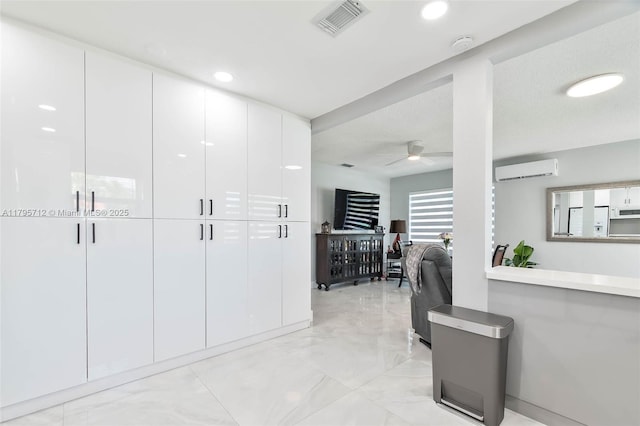 hallway with visible vents, recessed lighting, marble finish floor, and a wall mounted AC