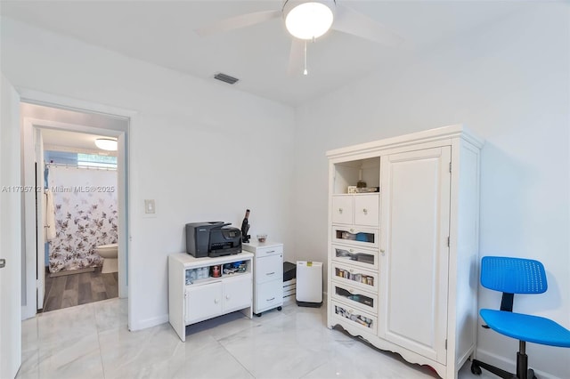 interior space featuring a ceiling fan, baseboards, visible vents, and marble finish floor