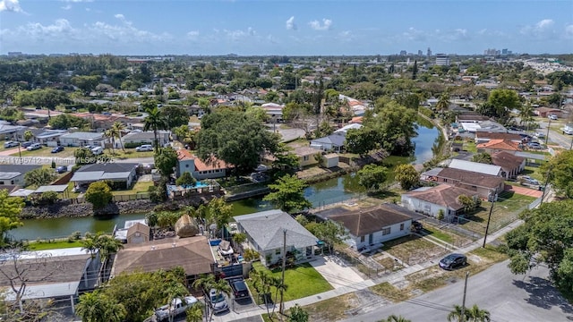 birds eye view of property with a water view and a residential view