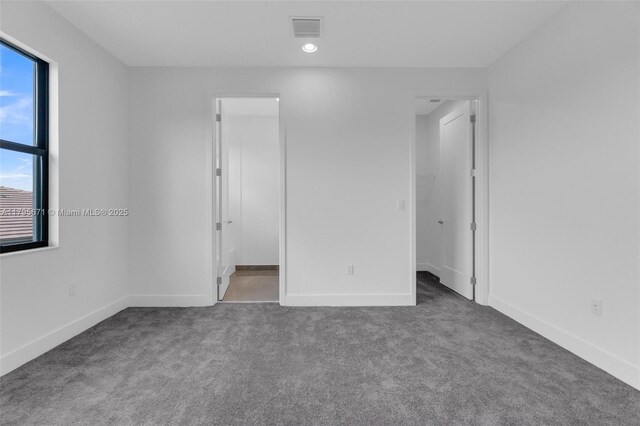 8215 Crystal Downs Ave, Boca Raton, FL 33434 - unfurnished bedroom featuring a spacious closet, carpet floors, and baseboards