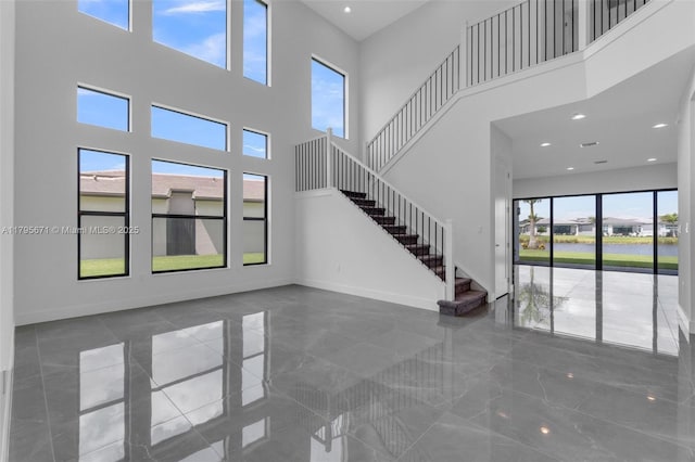 8215 Crystal Downs Ave, Boca Raton, FL 33434 - unfurnished living room featuring a towering ceiling, stairs, baseboards, marble tiled flooring, and recessed lighting