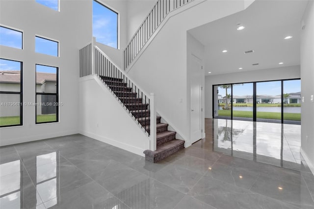 8215 Crystal Downs Ave, Boca Raton, FL 33434 - staircase featuring marble tiled flooring, baseboards, a high ceiling, and recessed lighting