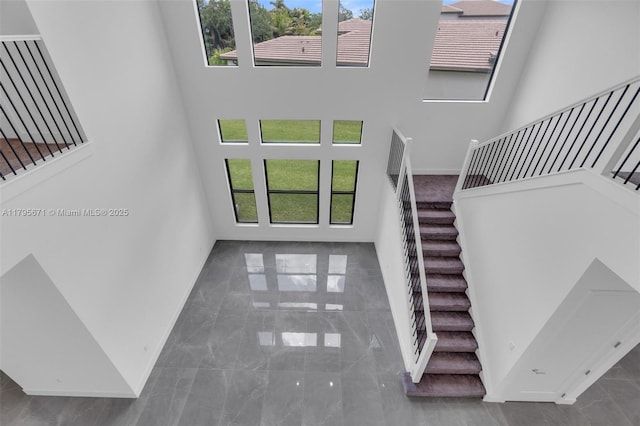 8215 Crystal Downs Ave, Boca Raton, FL 33434 - stairway with a high ceiling, marble finish floors, and baseboards