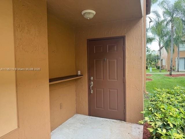 doorway to property with stucco siding