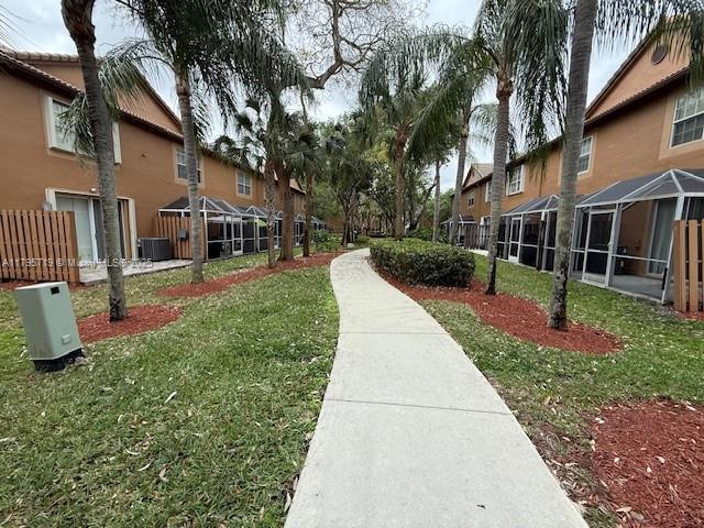 view of home's community featuring a lawn and a residential view
