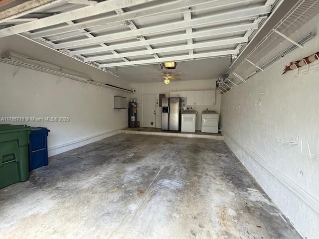 garage featuring separate washer and dryer, stainless steel fridge, a garage door opener, and water heater