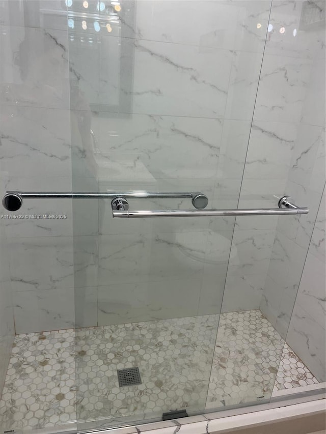full bathroom featuring a marble finish shower