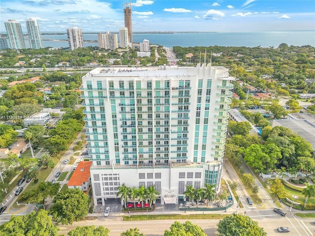 drone / aerial view featuring a view of city and a water view