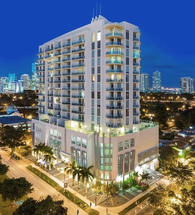 property at twilight featuring a view of city lights
