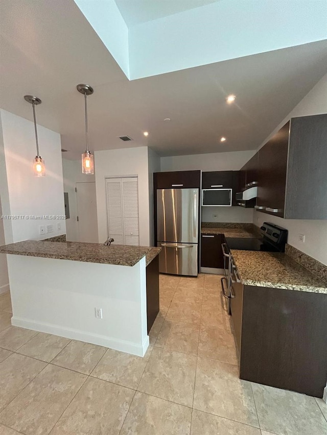 kitchen with recessed lighting, appliances with stainless steel finishes, under cabinet range hood, and dark stone countertops