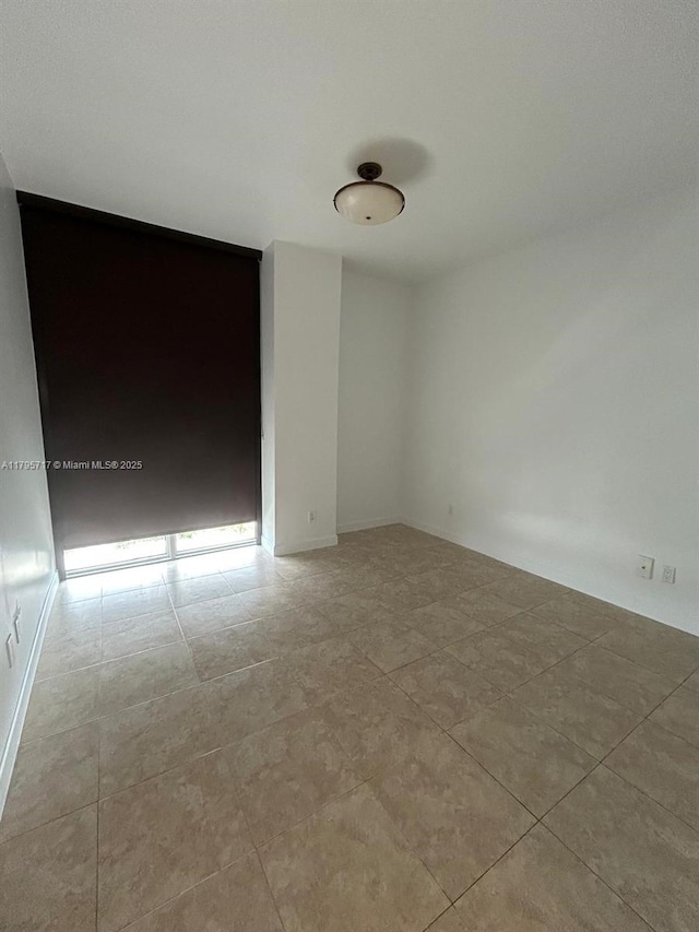 empty room with tile patterned floors