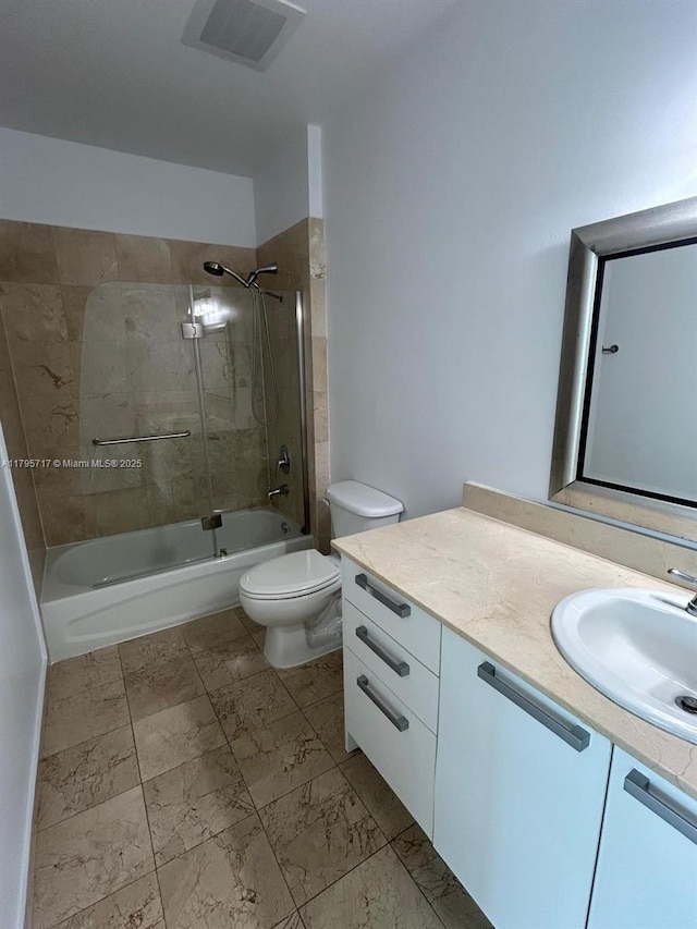 bathroom featuring vanity, bathtub / shower combination, toilet, marble finish floor, and visible vents