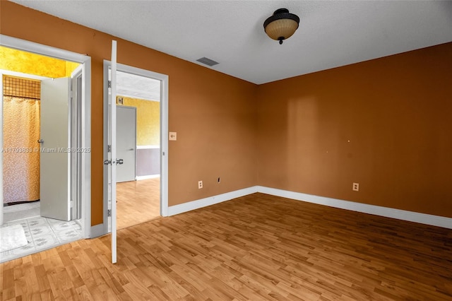 839 W 39th Pl, Hialeah, FL 33012 - spare room with light wood-style flooring and baseboards