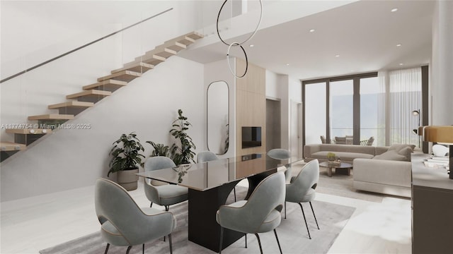 dining room featuring recessed lighting, expansive windows, and stairway