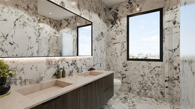 bathroom featuring double vanity, a sink, a marble finish shower, and toilet