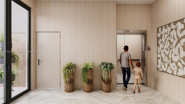 foyer featuring elevator and marble finish floor