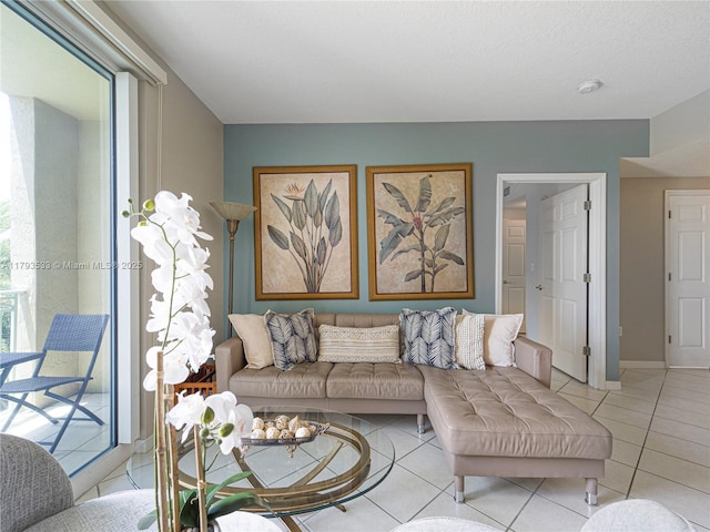 living room with baseboards and light tile patterned floors