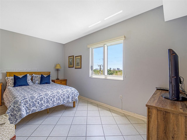 bedroom with baseboards and light tile patterned floors
