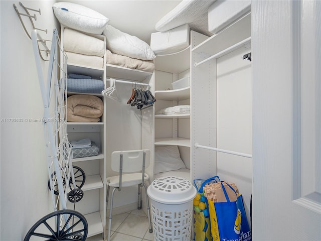 walk in closet with tile patterned flooring