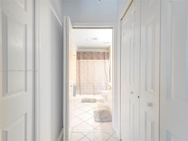 corridor featuring light tile patterned floors