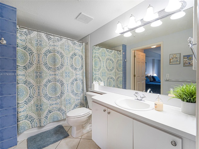 bathroom featuring visible vents, tile patterned flooring, vanity, toilet, and ensuite bath