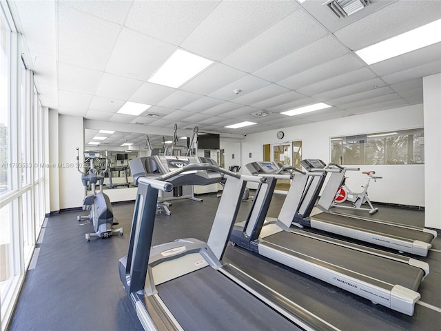 workout area with visible vents and a paneled ceiling