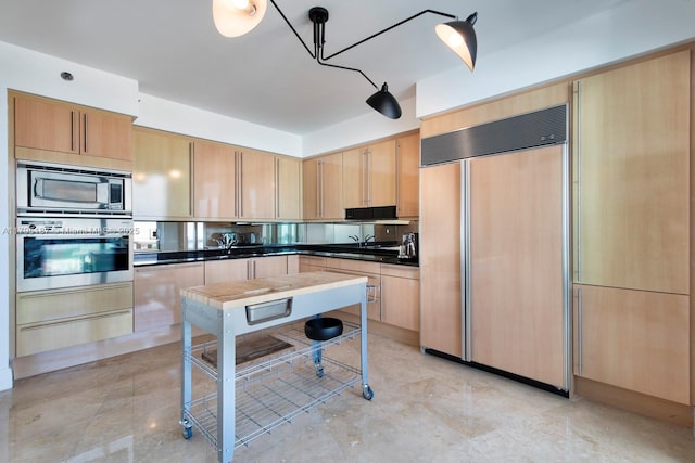 1000 S Pointe Dr Unit 1903, Miami Beach, FL 33139 - kitchen with built in appliances, a warming drawer, dark countertops, and light brown cabinetry