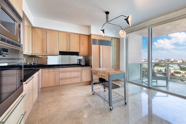 1000 S Pointe Dr Unit 1903, Miami Beach, FL 33139 - kitchen featuring decorative light fixtures, light brown cabinetry, dark countertops, expansive windows, and built in appliances