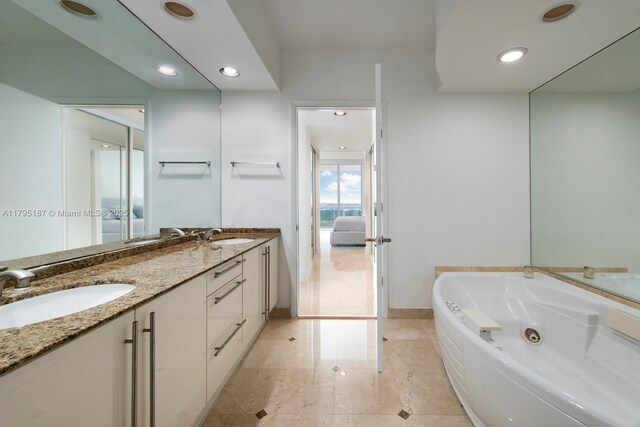 1000 S Pointe Dr Unit 1903, Miami Beach, FL 33139 - ensuite bathroom with double vanity, a tub with jets, recessed lighting, connected bathroom, and a sink