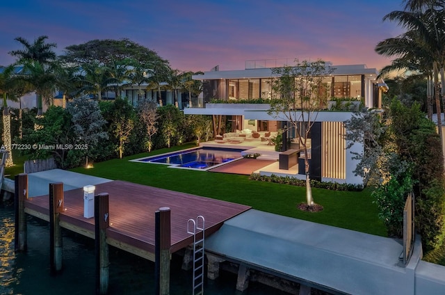 5515 Pine Tree Dr, Miami Beach, FL 33140 - back of house featuring an outdoor pool, a lawn, a patio, and an outdoor living space