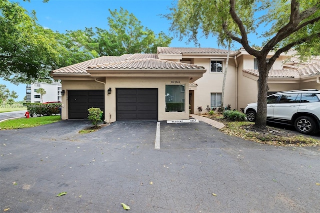 view of front of house featuring stucco siding and a tile roof