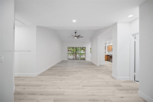 unfurnished living room featuring baseboards, recessed lighting, a ceiling fan, light wood-style flooring, and vaulted ceiling