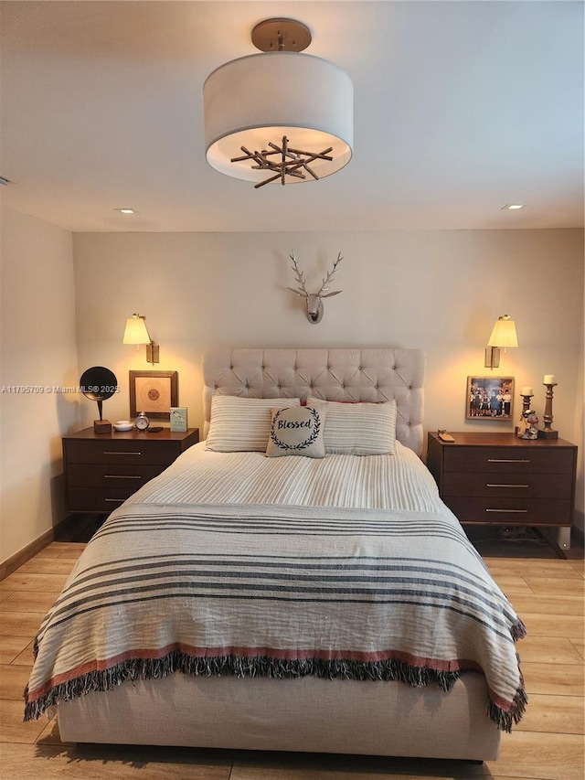 bedroom with light wood-style floors, baseboards, and recessed lighting