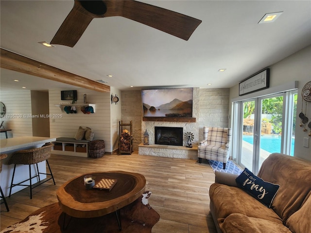 living room featuring visible vents, a fireplace, and hardwood / wood-style floors