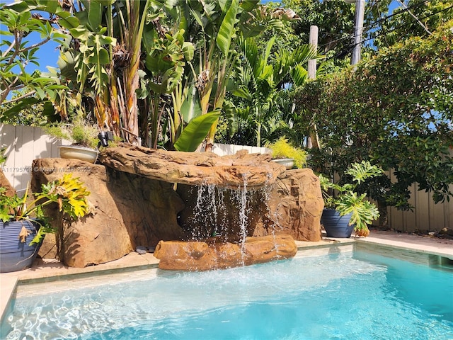 view of swimming pool featuring fence and a fenced in pool