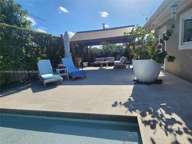 view of patio / terrace featuring fence, a gazebo, and outdoor lounge area