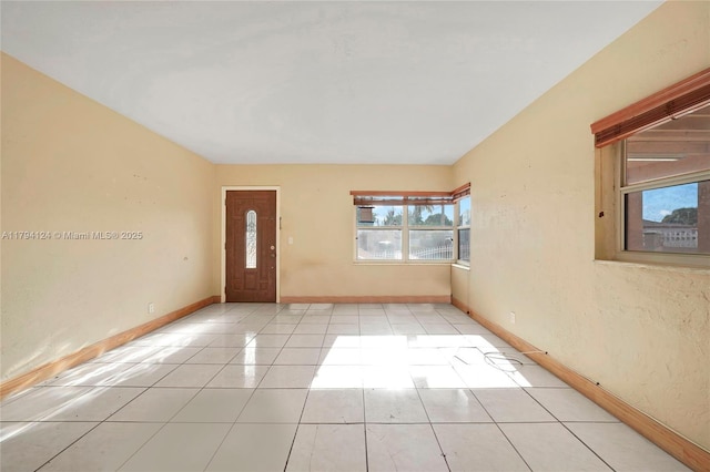4241 W 1st Ave, Hialeah, FL 33012 - entryway with baseboards and light tile patterned flooring