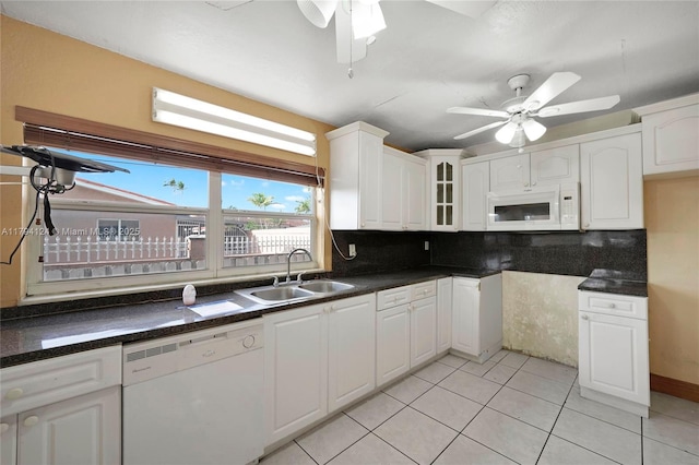 4241 W 1st Ave, Hialeah, FL 33012 - kitchen with decorative backsplash, a ceiling fan, white appliances, white cabinets, and a sink