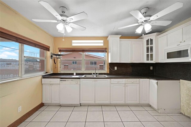 4241 W 1st Ave, Hialeah, FL 33012 - kitchen featuring a sink, ceiling fan, white cabinets, and white appliances